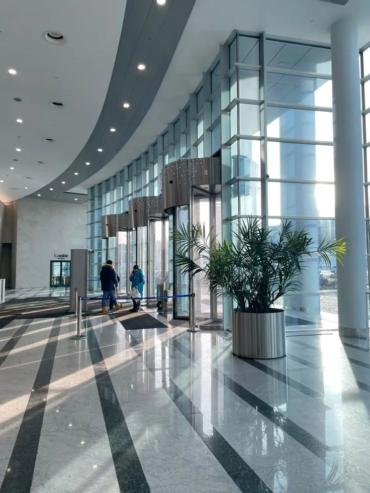 Ahli Bank lobby with HD Plus Blue solar-control glass curtain wall and revolving entrance doors